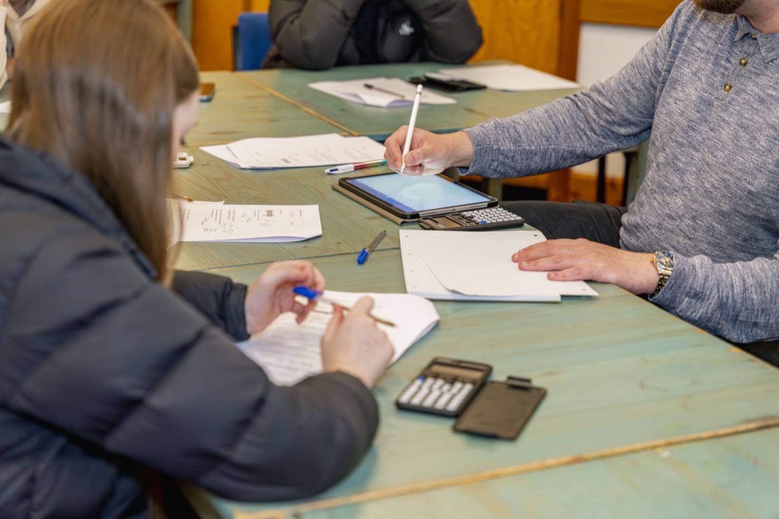 A tutor and student working through Maths problems 1-to-1